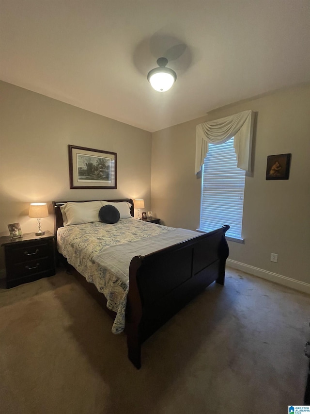 bedroom featuring carpet and baseboards