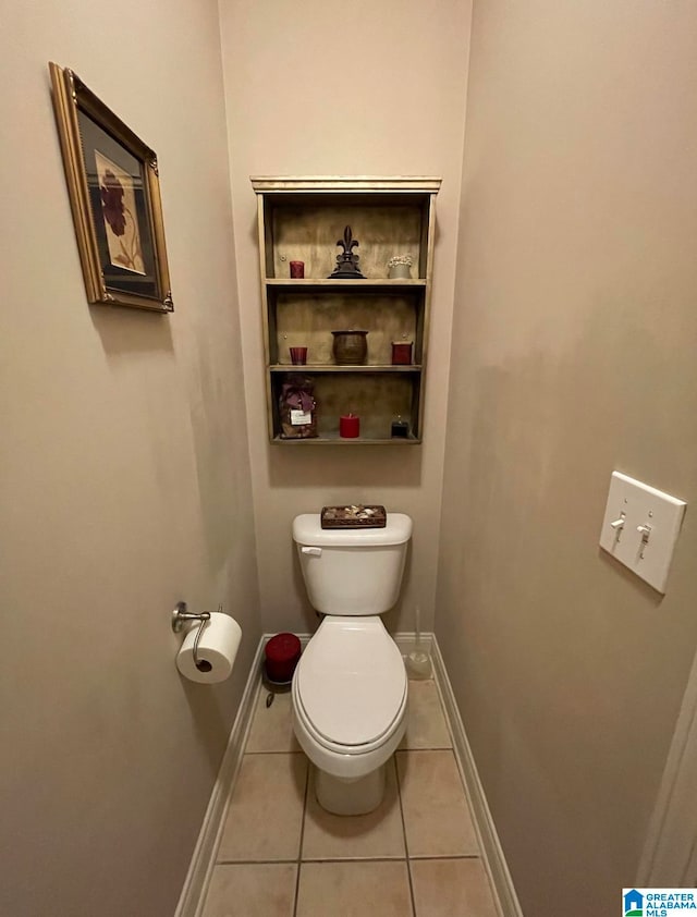 bathroom with tile patterned flooring and toilet