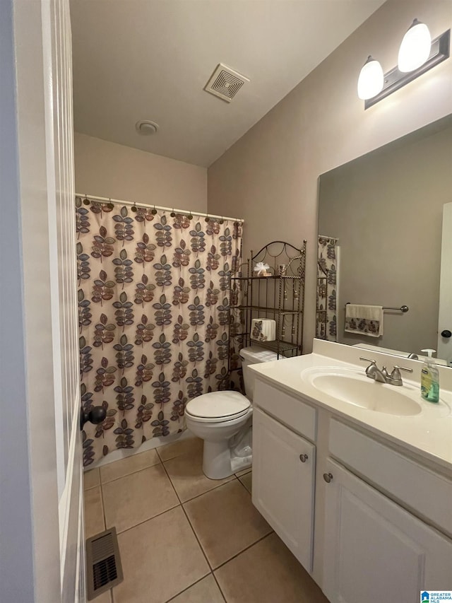 full bath featuring toilet, vanity, visible vents, and tile patterned floors