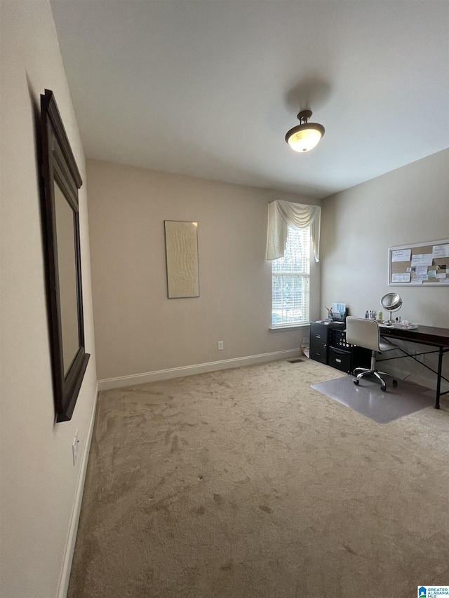 carpeted office featuring baseboards