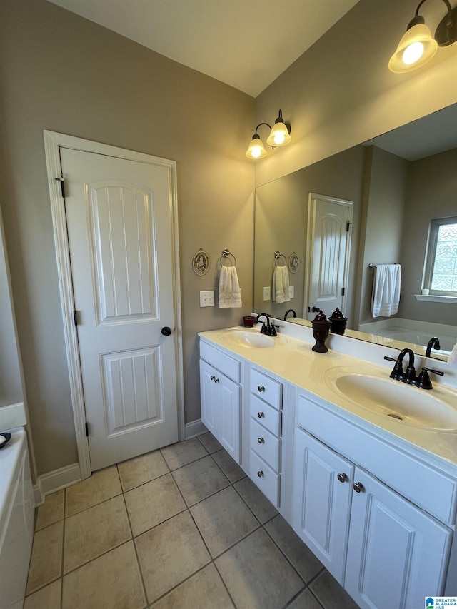 full bathroom featuring double vanity, a garden tub, tile patterned flooring, and a sink