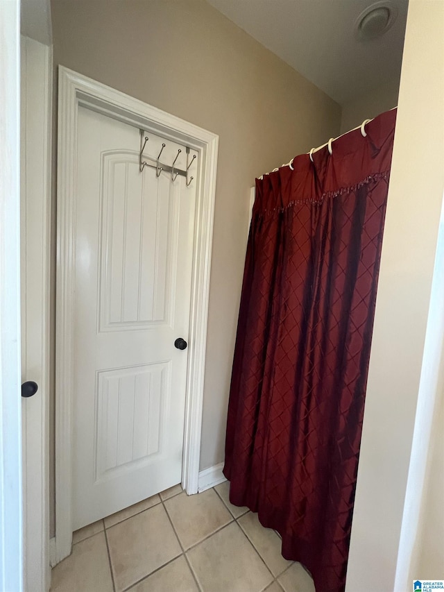 full bath with tile patterned flooring