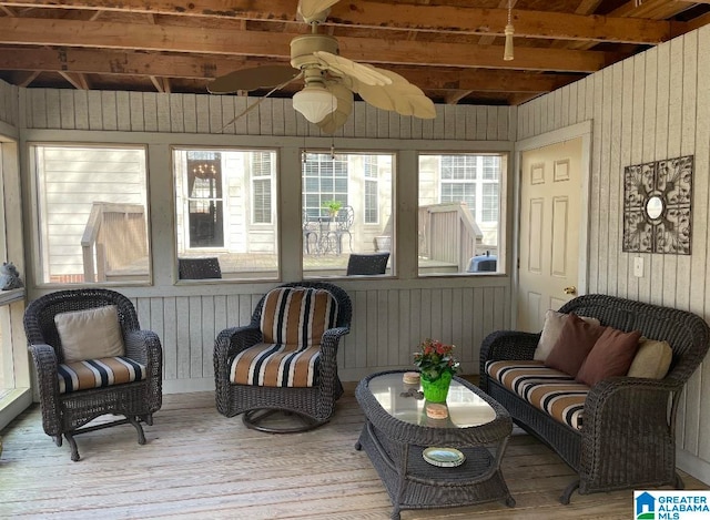 sunroom with beamed ceiling, wood ceiling, and ceiling fan