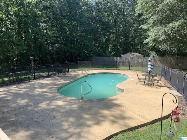 view of swimming pool featuring a patio area, a fenced backyard, and a fenced in pool