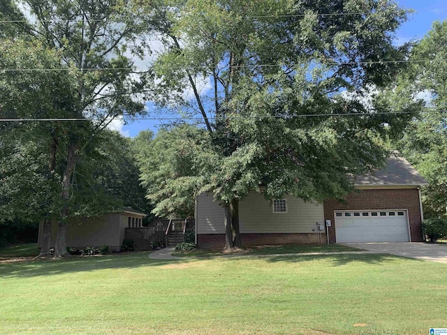 view of front of house with brick siding, driveway, stairway, and a front lawn