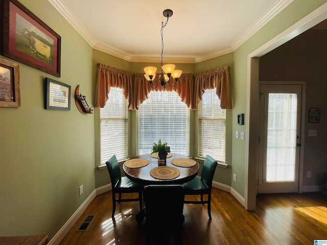 dining room featuring a notable chandelier, hardwood / wood-style floors, and ornamental molding