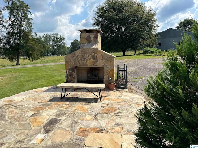 view of patio with an outdoor stone fireplace