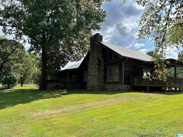 view of home's exterior featuring a deck and a yard