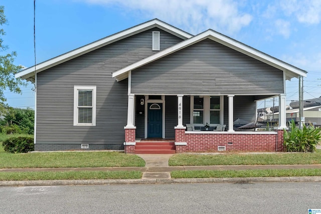 view of front of house featuring a front yard and a porch