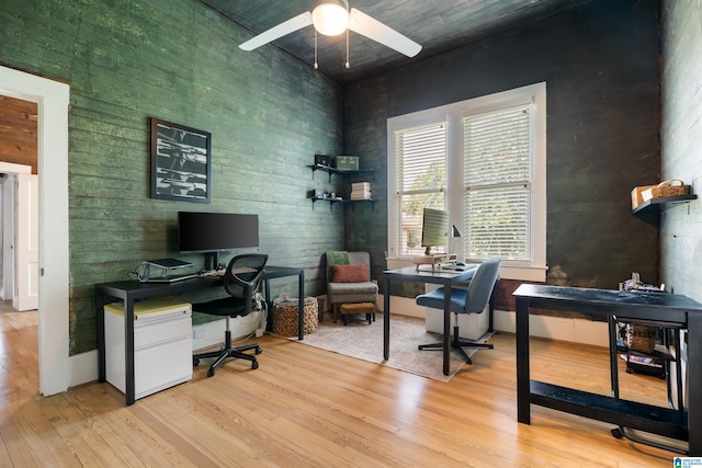 home office featuring ceiling fan and light hardwood / wood-style flooring