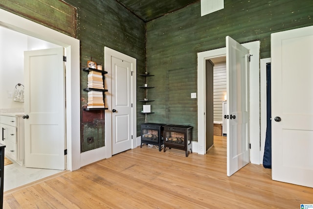 interior space featuring a wood stove and light wood-type flooring