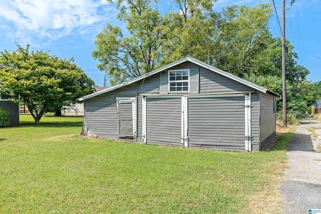 view of home's exterior featuring a yard and an outdoor structure