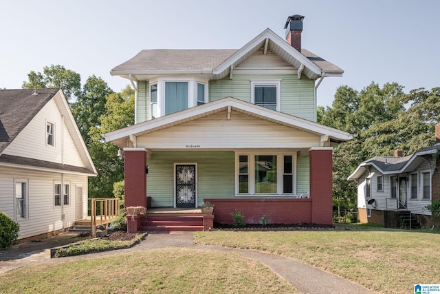 view of front of home featuring covered porch and a front yard