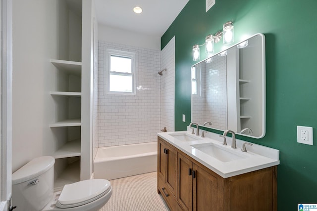 full bathroom featuring built in shelves, vanity, tile patterned floors, toilet, and tiled shower / bath combo