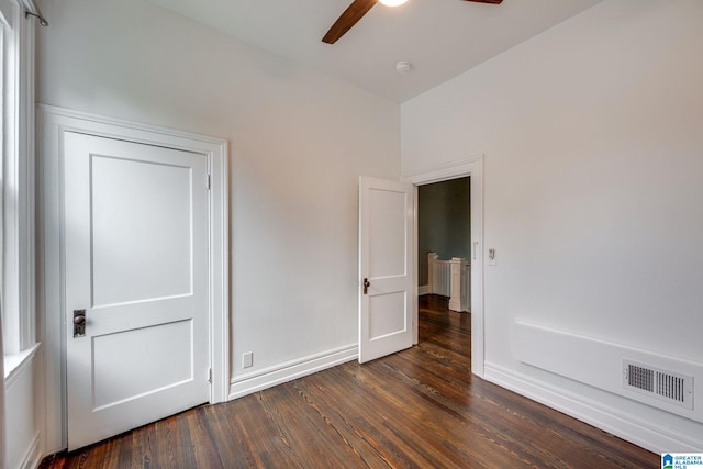 empty room featuring ceiling fan and dark hardwood / wood-style floors