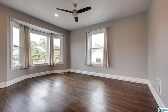 empty room with ceiling fan and dark hardwood / wood-style floors