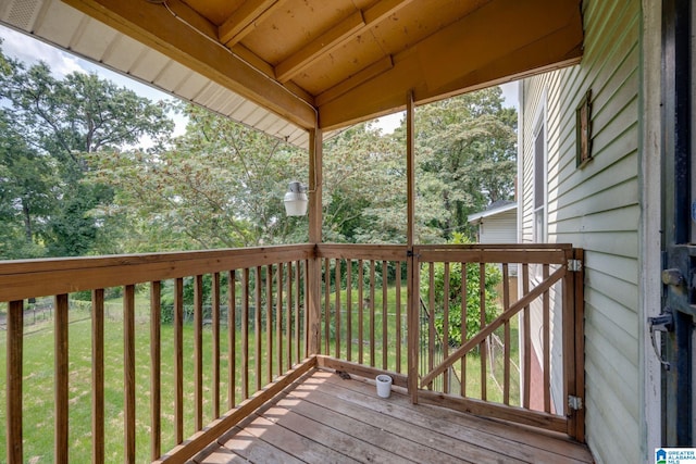 wooden terrace with a lawn