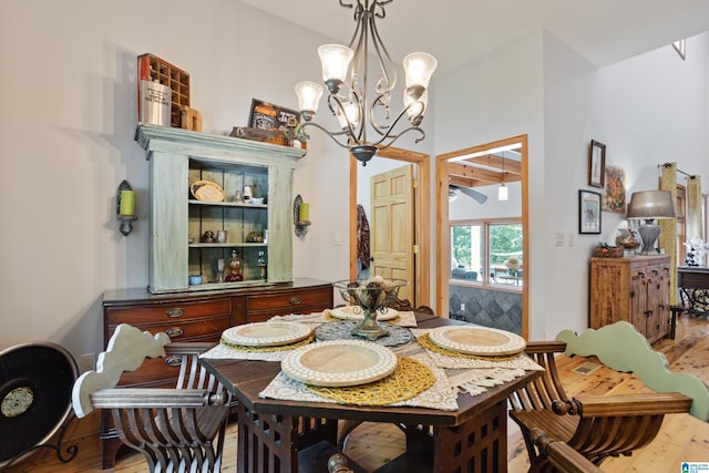 dining room with light hardwood / wood-style flooring and a chandelier