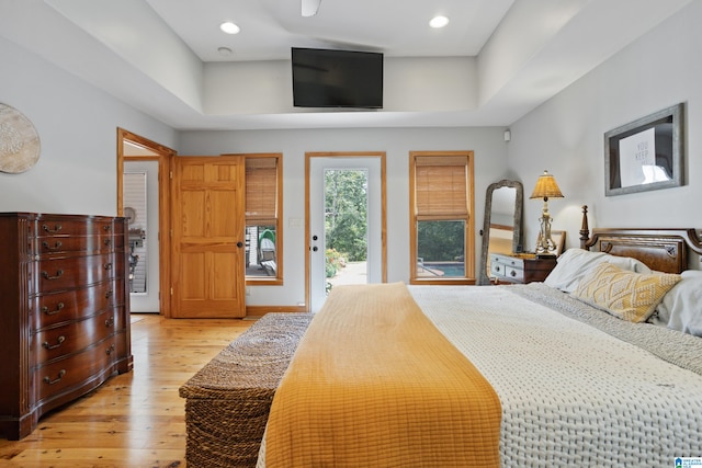 bedroom featuring light hardwood / wood-style floors and access to exterior