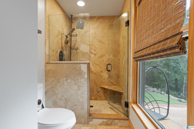 bathroom with toilet and walk in shower