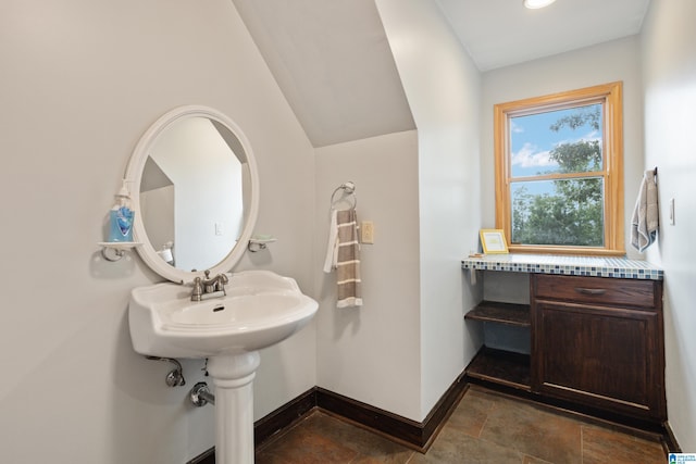 bathroom with tile patterned flooring and lofted ceiling