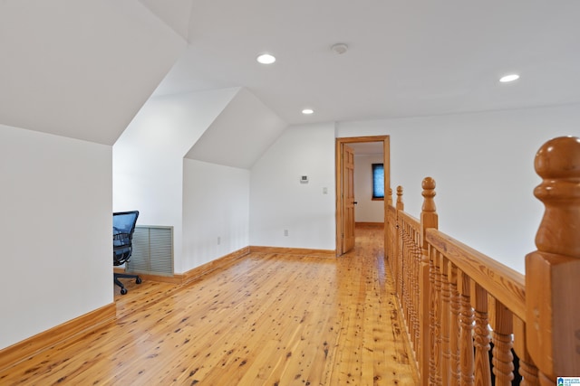 bonus room with light hardwood / wood-style flooring and lofted ceiling