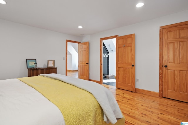 bedroom featuring light hardwood / wood-style floors and ensuite bathroom