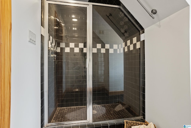 bathroom with a shower with door