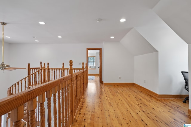 hallway with hardwood / wood-style floors