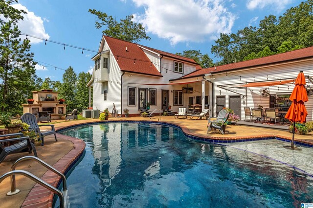 view of swimming pool with a patio and cooling unit