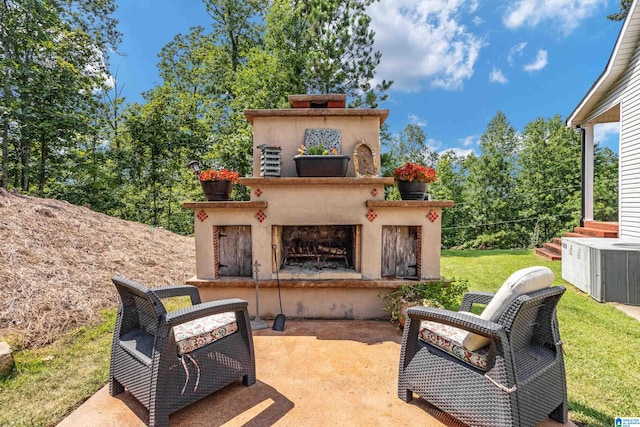 view of patio / terrace featuring exterior fireplace and central air condition unit