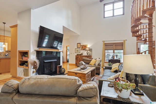 tiled living room with a fireplace and a high ceiling