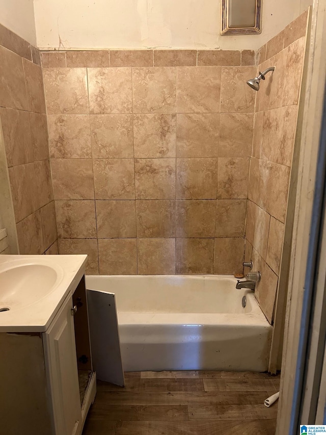 full bathroom featuring  shower combination, wood finished floors, and vanity