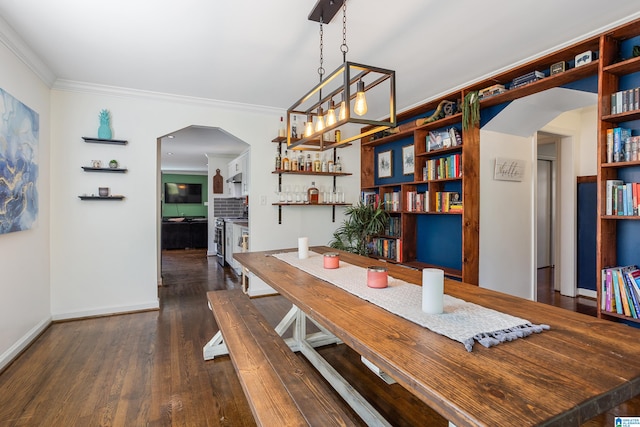 dining area featuring crown molding and dark wood-type flooring