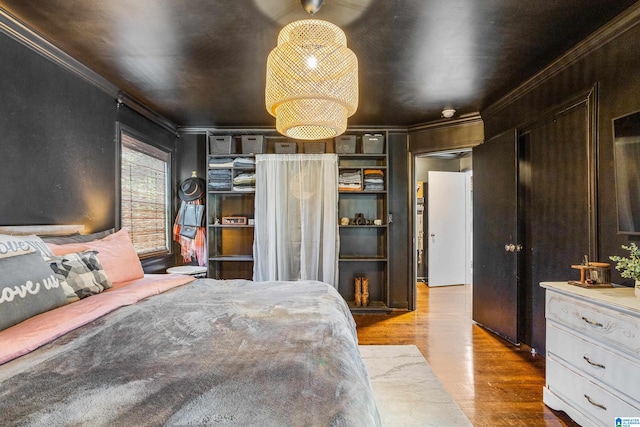 bedroom featuring light hardwood / wood-style flooring and ornamental molding