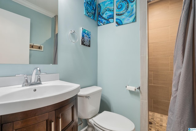 bathroom with tiled shower, vanity, toilet, and ornamental molding