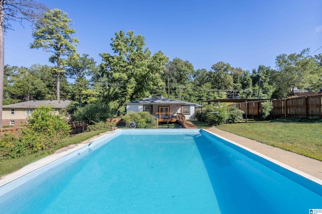 view of pool featuring a yard and a deck