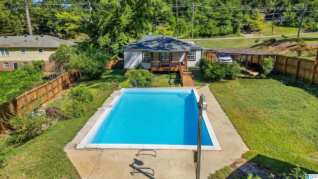 view of pool with a lawn and a deck