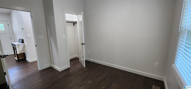 unfurnished bedroom featuring dark wood-type flooring