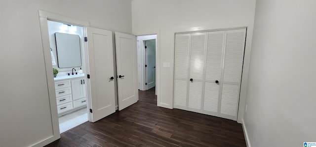 unfurnished bedroom featuring sink and dark hardwood / wood-style flooring