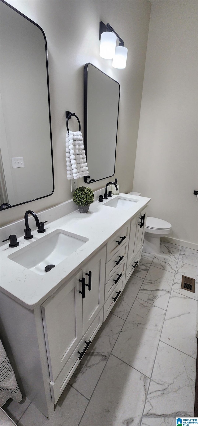 bathroom with toilet and vanity