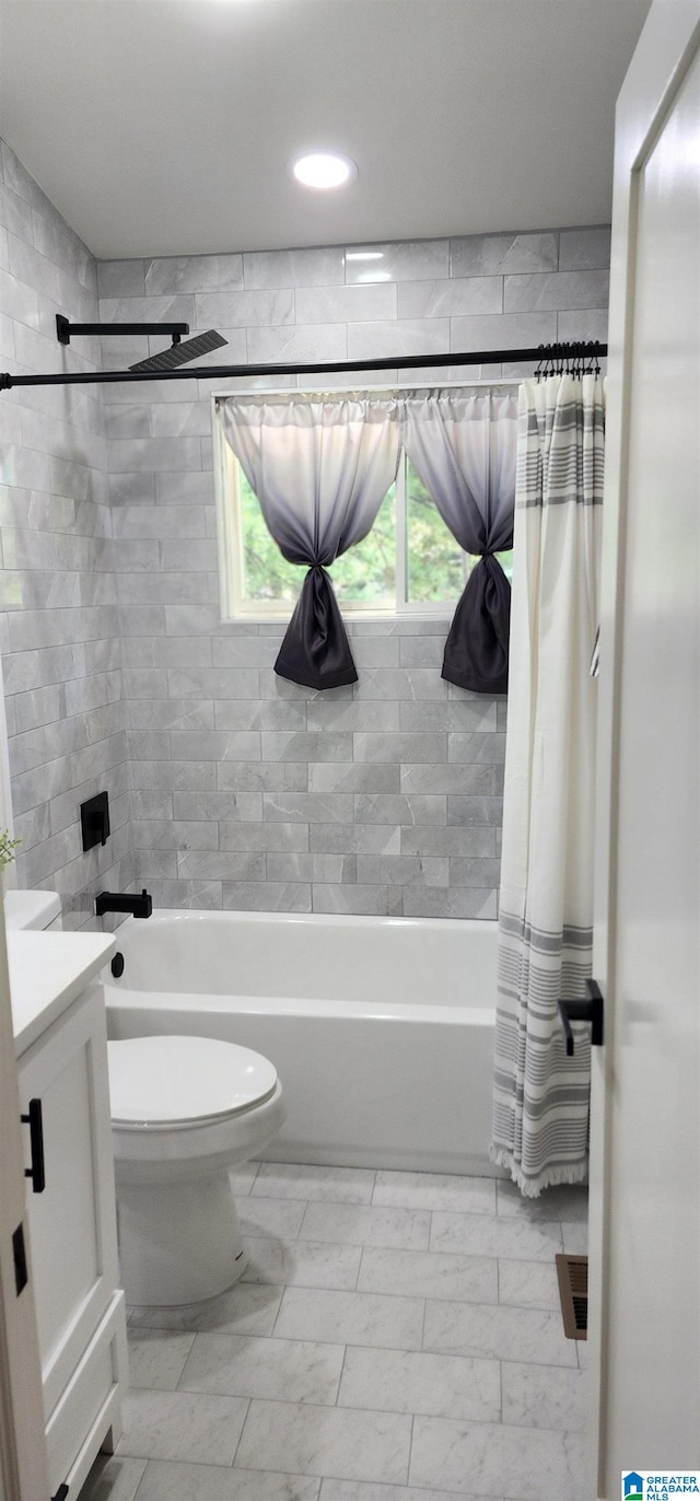 full bathroom with shower / bath combo with shower curtain, toilet, and vanity