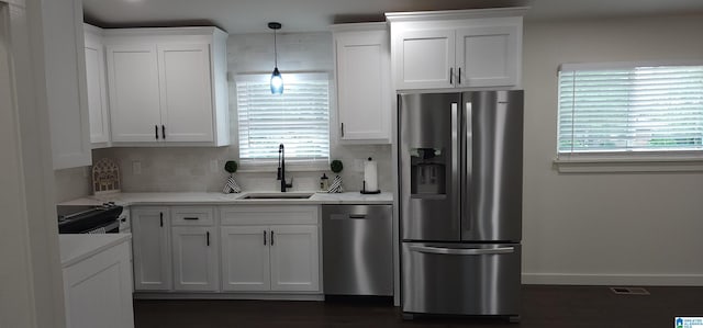 kitchen featuring a healthy amount of sunlight, stainless steel appliances, and white cabinetry