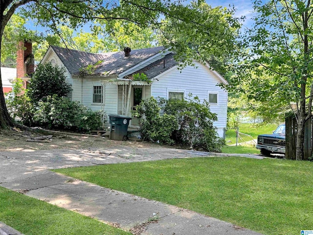 rear view of property featuring a yard