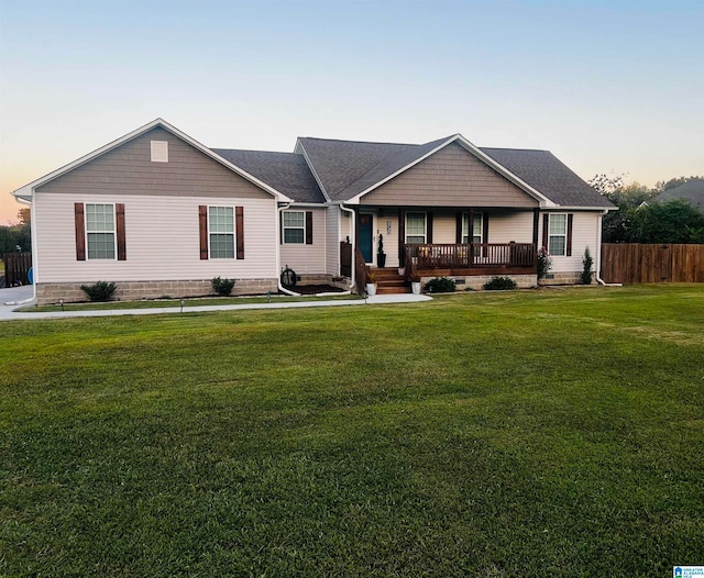 single story home featuring a yard and a porch