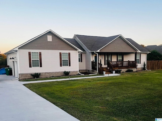 view of front of house with a porch and a lawn