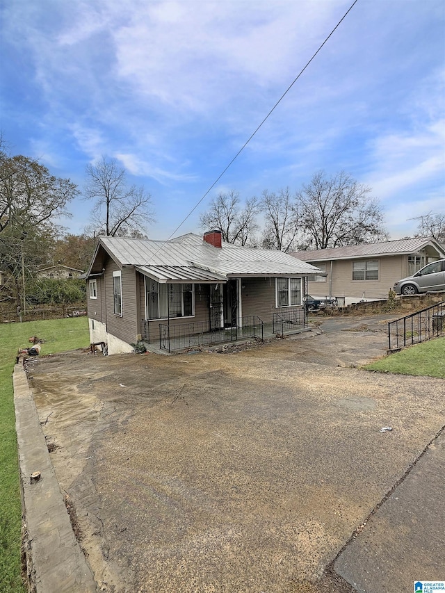 view of front of home featuring metal roof and covered porch