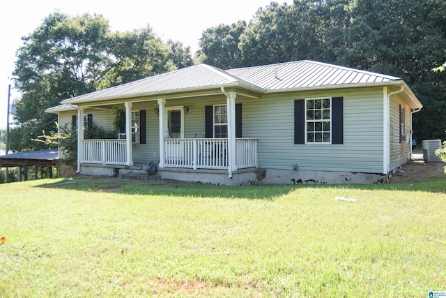 view of front of property featuring a front lawn, covered porch, and central AC unit