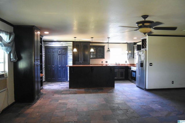 kitchen featuring stainless steel fridge, decorative light fixtures, stove, sink, and ceiling fan