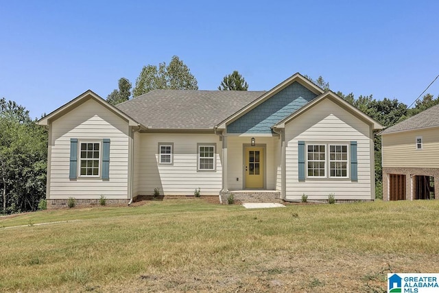 ranch-style house with roof with shingles and a front yard